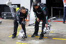 Mercedes mechanics prepare for the program after the rain
