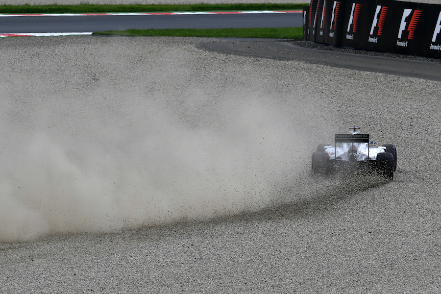 Romain Grosjean runs through the gravel in Q2