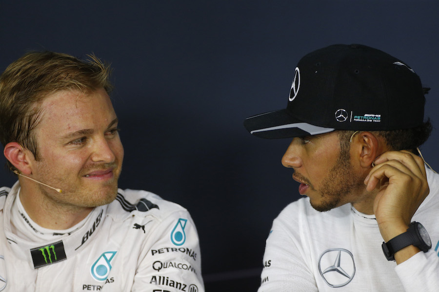 Lewis Hamilton and Nico Rosberg chat during the press conference after qualifying