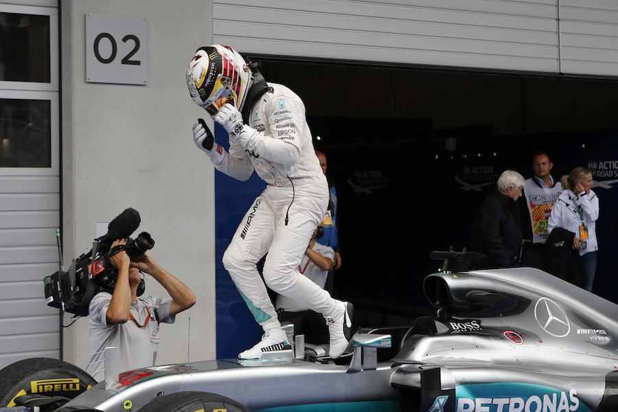 Race winner Lewis Hamilton cereblates in the parc ferme