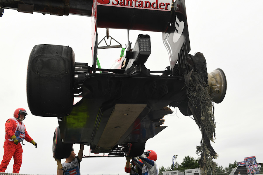 The car of race retiree Sebastian Vettel is recovered