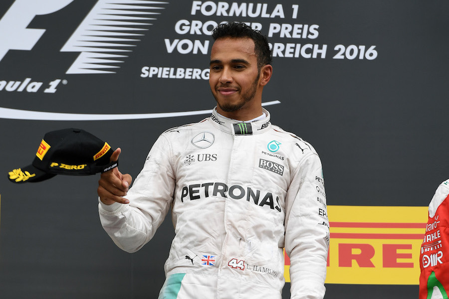 Lewis Hamilton smiles on the podium
