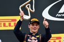 Max Verstappen celebrates with the trophy on the podium