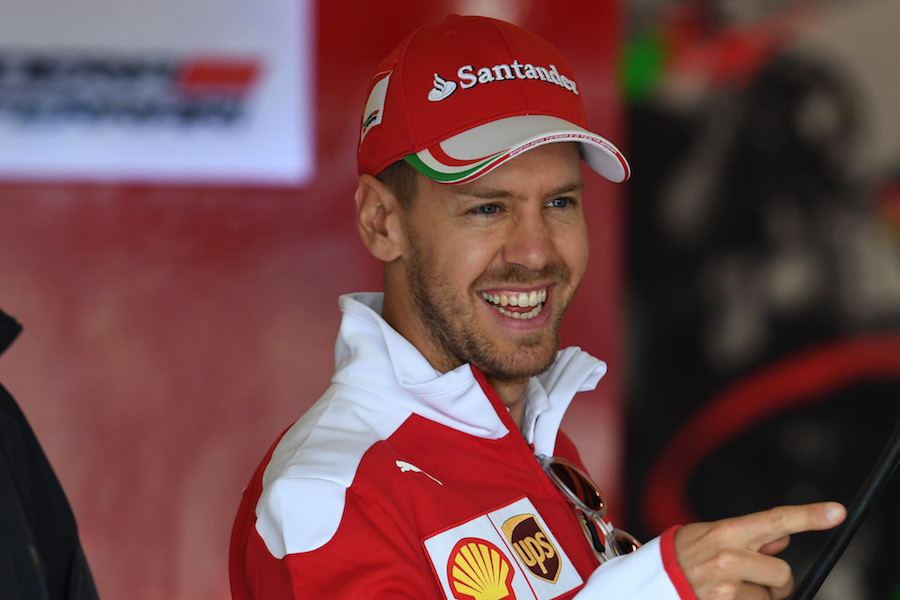 Sebastian Vettel smiles in the garage