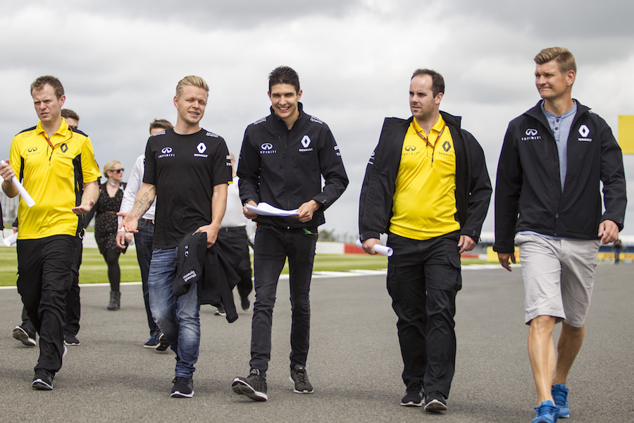 Kevin Magnussen and Esteban Ocon walks the track with Reanult members