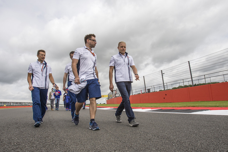 Valtteri Bottas walks the track with Williams engineers