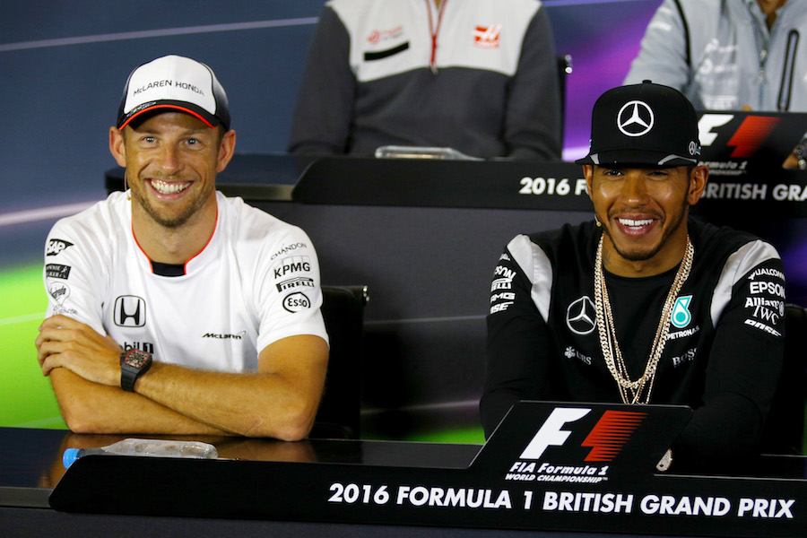 Jenson Button and Lewis Hamilton smile at the press conference