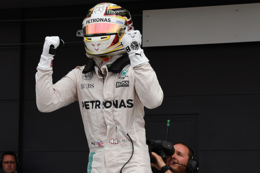 Lewis Hamilton celebrates taking pole position in parc ferme