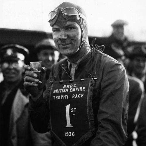 Dick Seaman, winner of the British Empire Trophy Race at Donington Park, celebrates with a drink