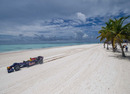 Jaime Alguersuari drives an F1 car on the white sands of the Dominican Republic