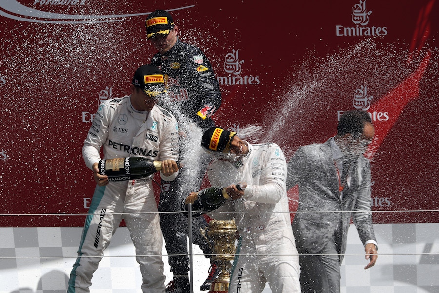 Top 3 drivers celebrate with the champagne on the podium