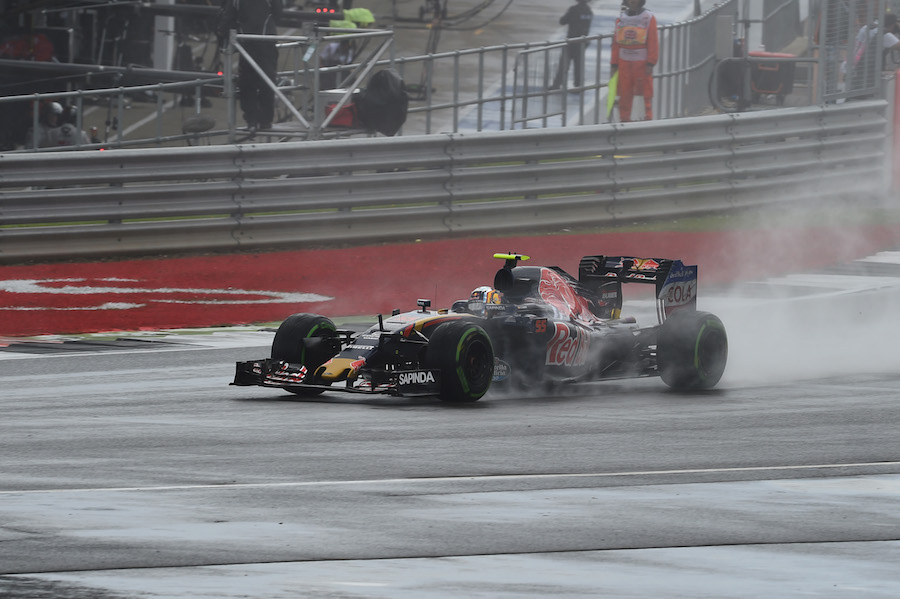 Carlos Sainz drives through the spray