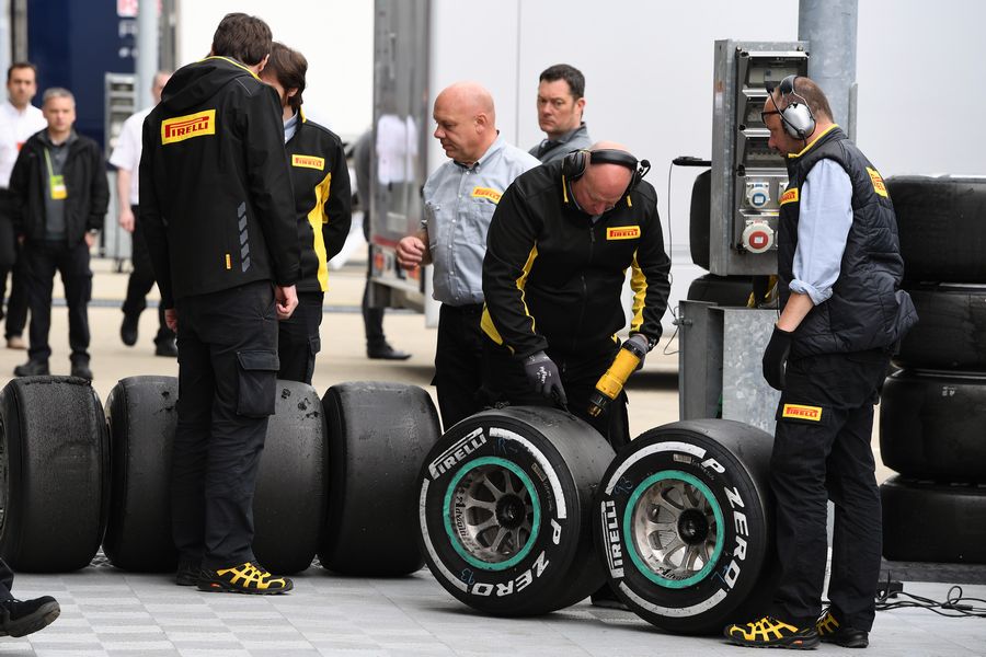 Pirelli engineers look at Pirelli tyres in the paddock