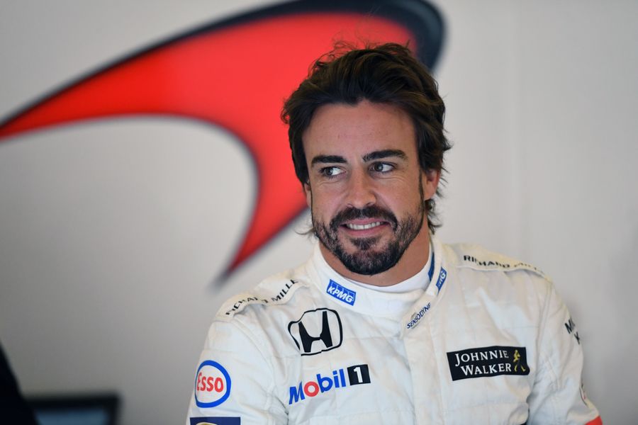 Fernando Alonso looks relaxed in the garage