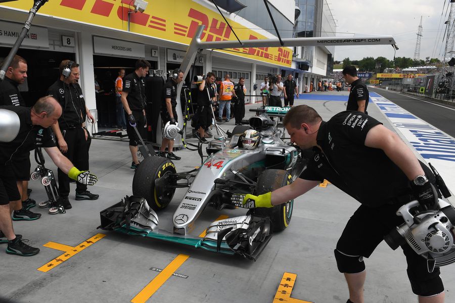 Lewis Hamilton returns to the pit following his crash in FP2