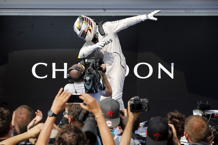 Lewis Hamilton celebrates his win in parc ferme