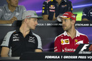 Nico Hulkenberg speaks with Sebastian Vettel during the press conference