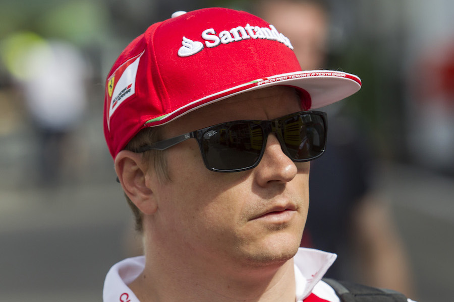 Kimi Raikkonen walks through the paddock