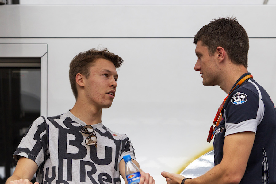 Daniil Kvyat talks with a team member