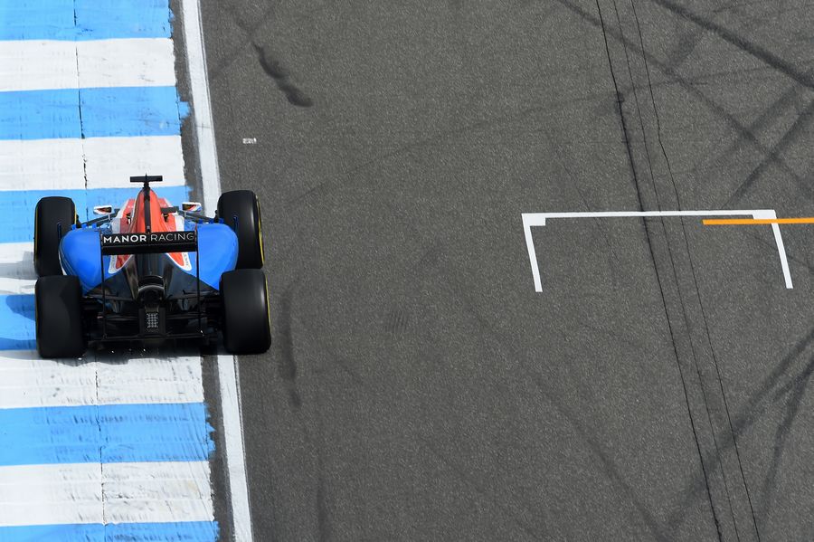 Pascal Wehrlein rides the kerb in the Manor