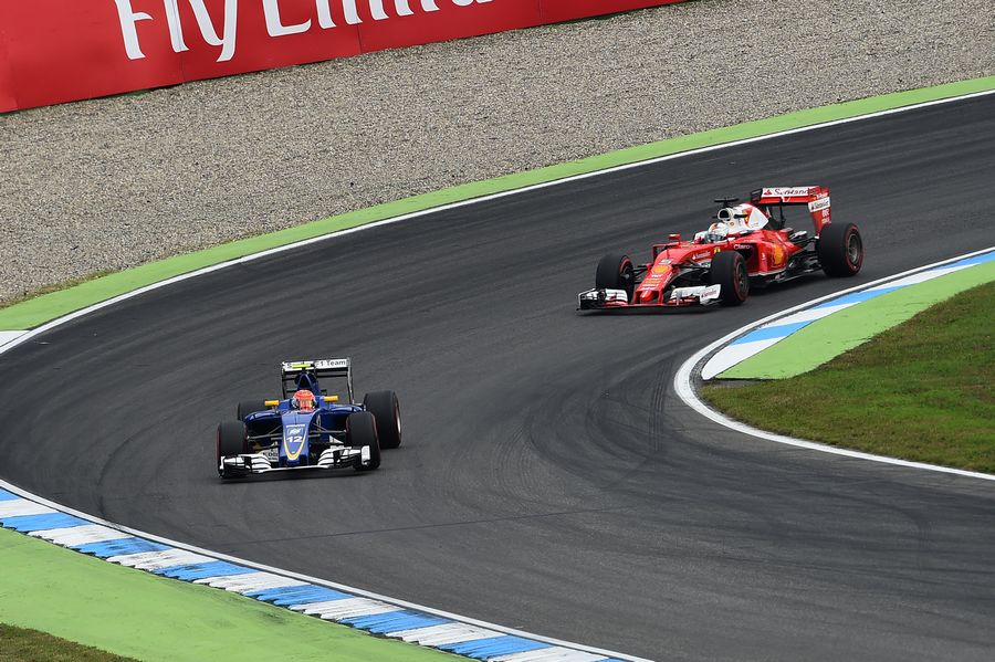 Felipe Nasr in the Sauber leads Sebastian Vettel in the Ferrari