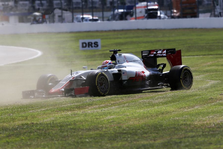 Romain Grosjean spins across the grass