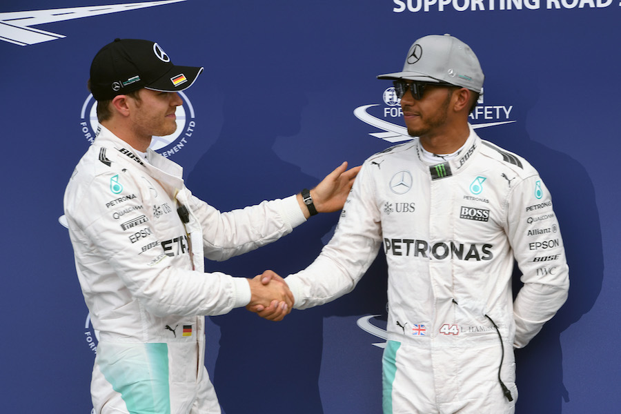 Nico Rosberg and Lewis Hamilton shake hands in parc ferme after qualifying