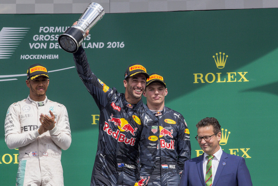 Daniel Ricciardo celebrate on the podium with the trophy