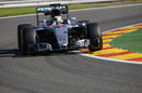 Lewis Hamilton cranks on the steering lock in the Mercedes