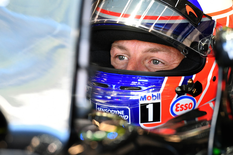 Jenson Button sits in the McLaren cockpit