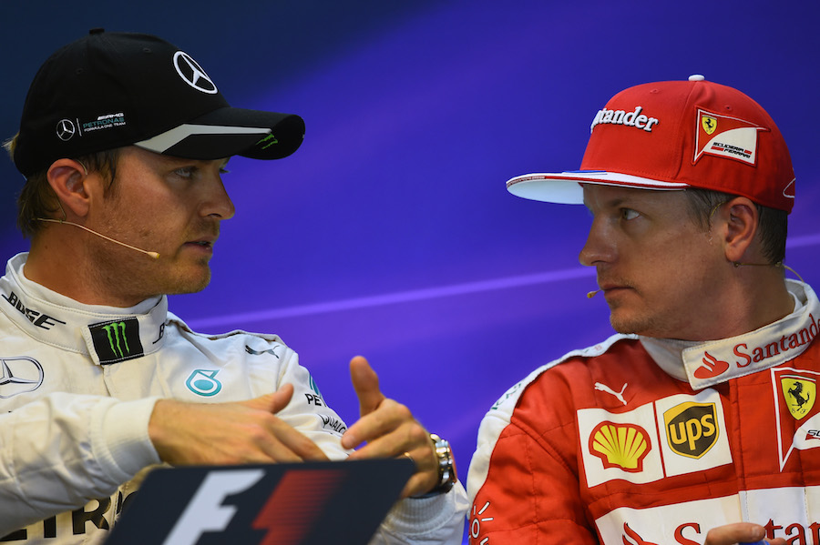 Nico Rosberg and Kimi Raikkonen chat during the press conference after qualifying 