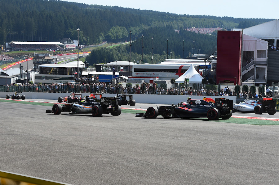 Sergio Perez and Jenson Button run wide at the start of the race