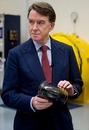 Lord Mandelson holds a car's nose tip during a visit to the Williams factory 