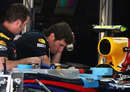 Mark Webber keeps an eye on the preparations of his Red Bull