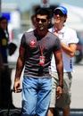 HRT drivers Karun Chandhok and Bruno Senna arrive in the paddock