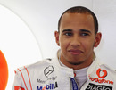 Lewis Hamilton sits at the back of the McLaren garage