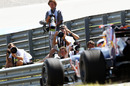 Photographers watch a Red Bull leave the pit lane
