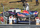 Mark Webber's Red Bull is lifted on to a flatbed truck