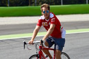 Sebastian Vettel rides a bike on track