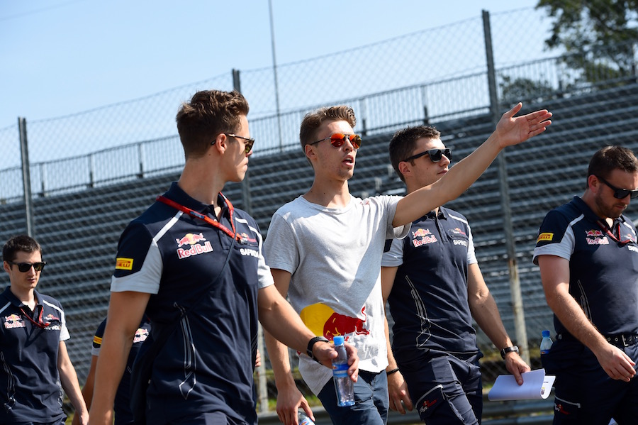 Daniil Kvyat walks the track with his engineers