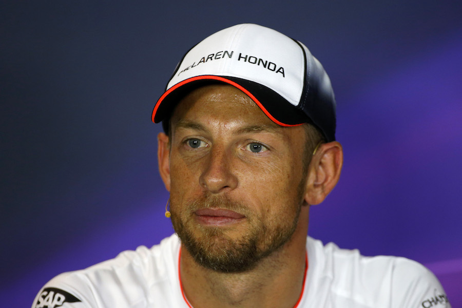 Jenson Button talks to the media in the press conference