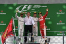 Nico Rosberg, Lewis Hamilton and Sebastian Vettel acknowledge the crowd during a podium ceremony