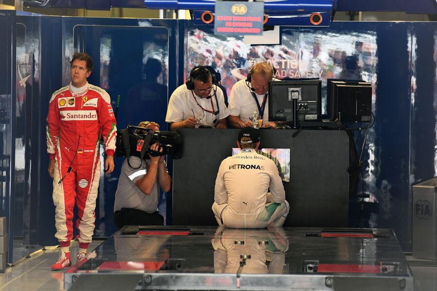 Nico Rosberg and Sebastian Vettel in parc ferme after qualifying