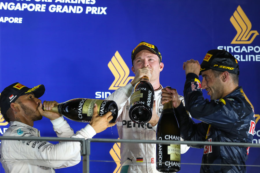 Top three drivers celebrate on the podium with the champagne