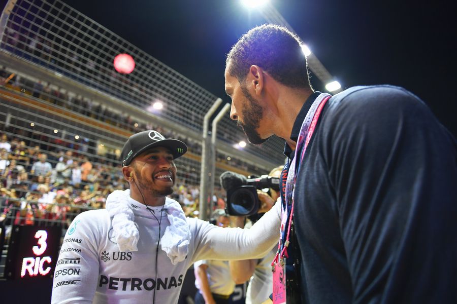Lewis Hamilton talks with Rio Ferdinand on the grid