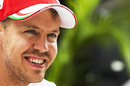 Sebastian Vettel looks on in the paddock