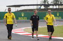 Kevin Magnussen walks the track with his engineers