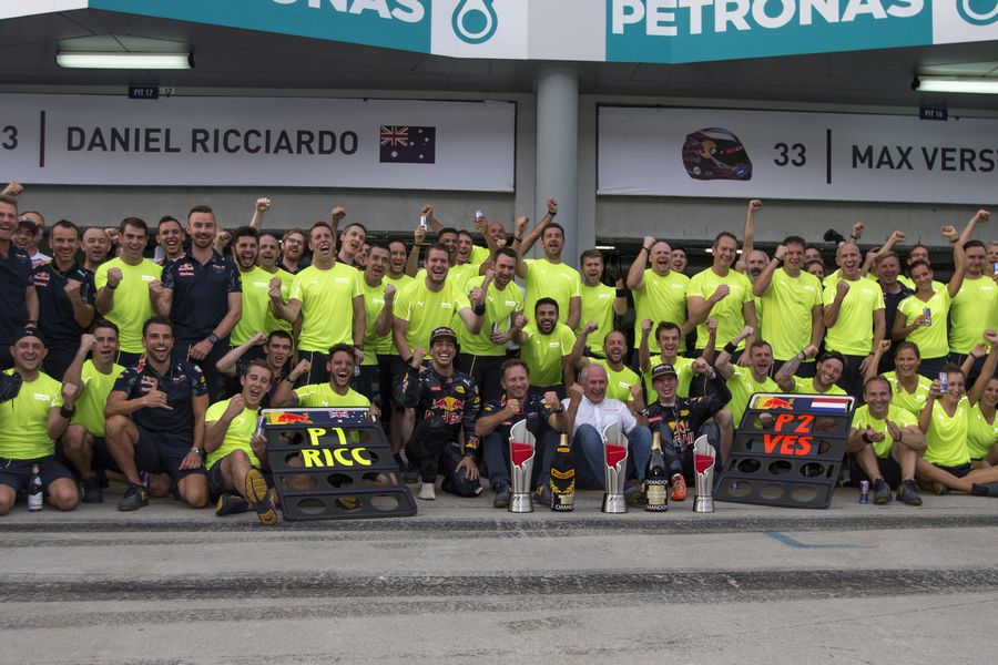 Daniel Ricciardo celebrates with Max Verstappen and all team members