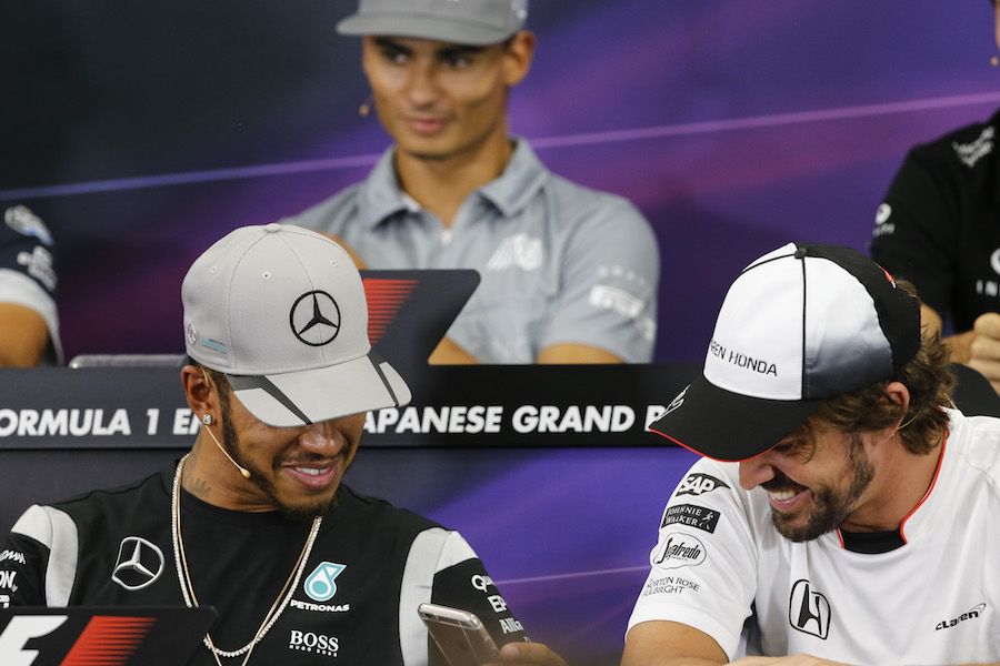 Lewis Hamilton and Fernando Alonso chat during the press conference