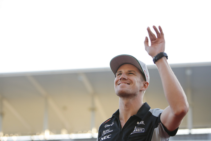 Nico Hulkenberg waves to fans with a smile on his face